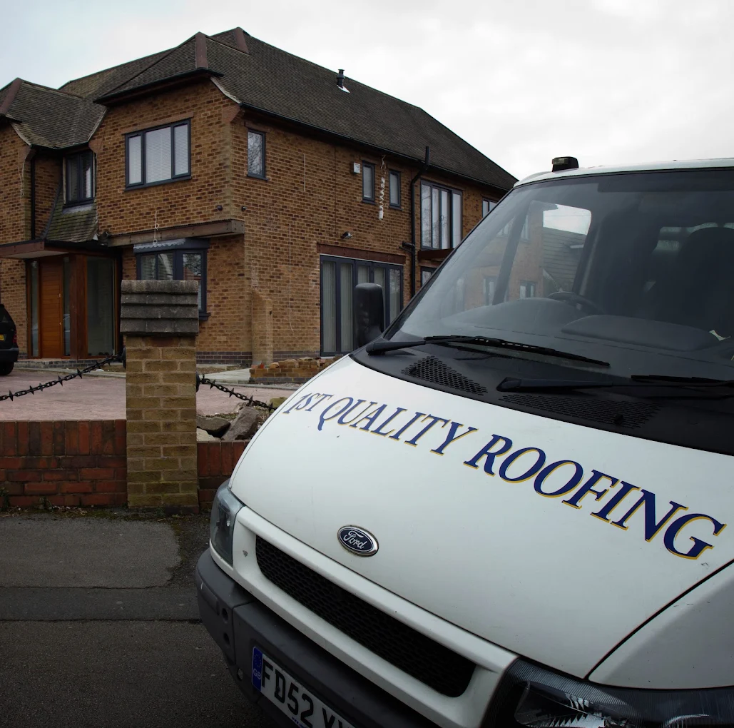 The 1st Quality Roofing van parked outside a brick house